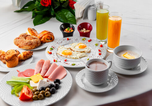 high-angle-view-delicious-breakfast-table-with-salad-fried-eggs-pastry-white-background-horizontal (1)